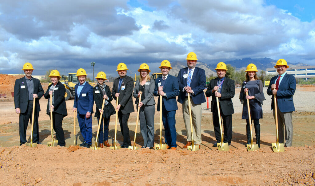 NexCore community at the groundbreaking ceremony holding shovels and wearing hard hats.