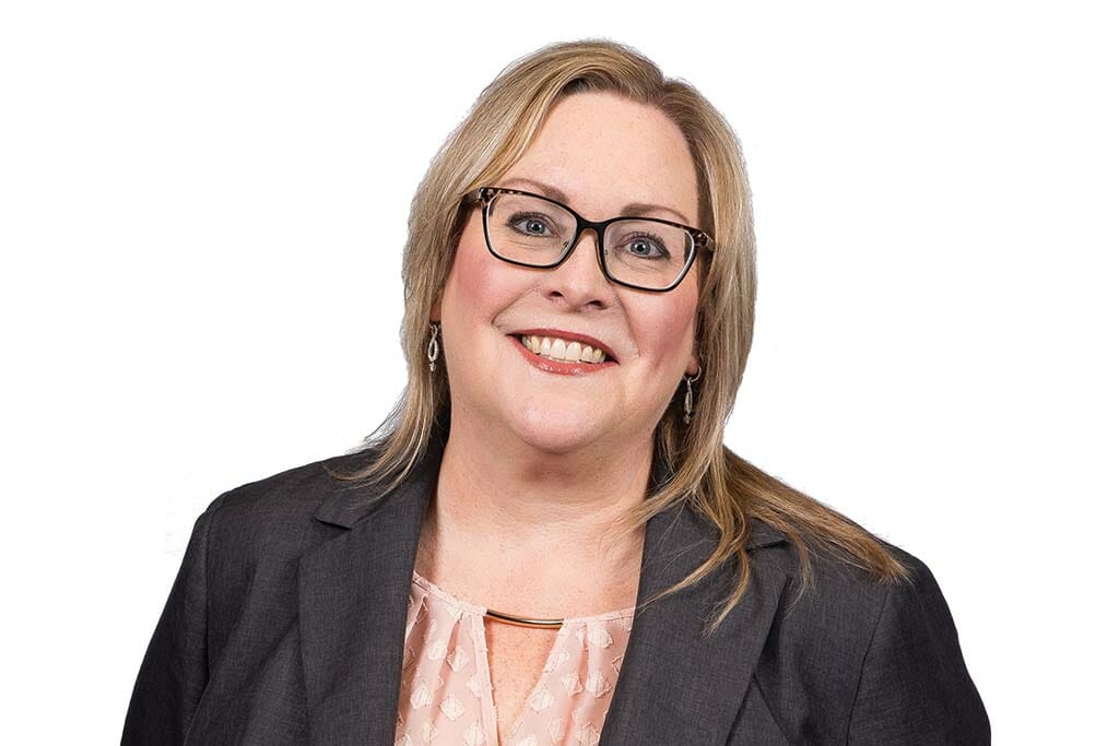 Headshot of Jeanette Allen. Blonde hair, glasses and smiling.