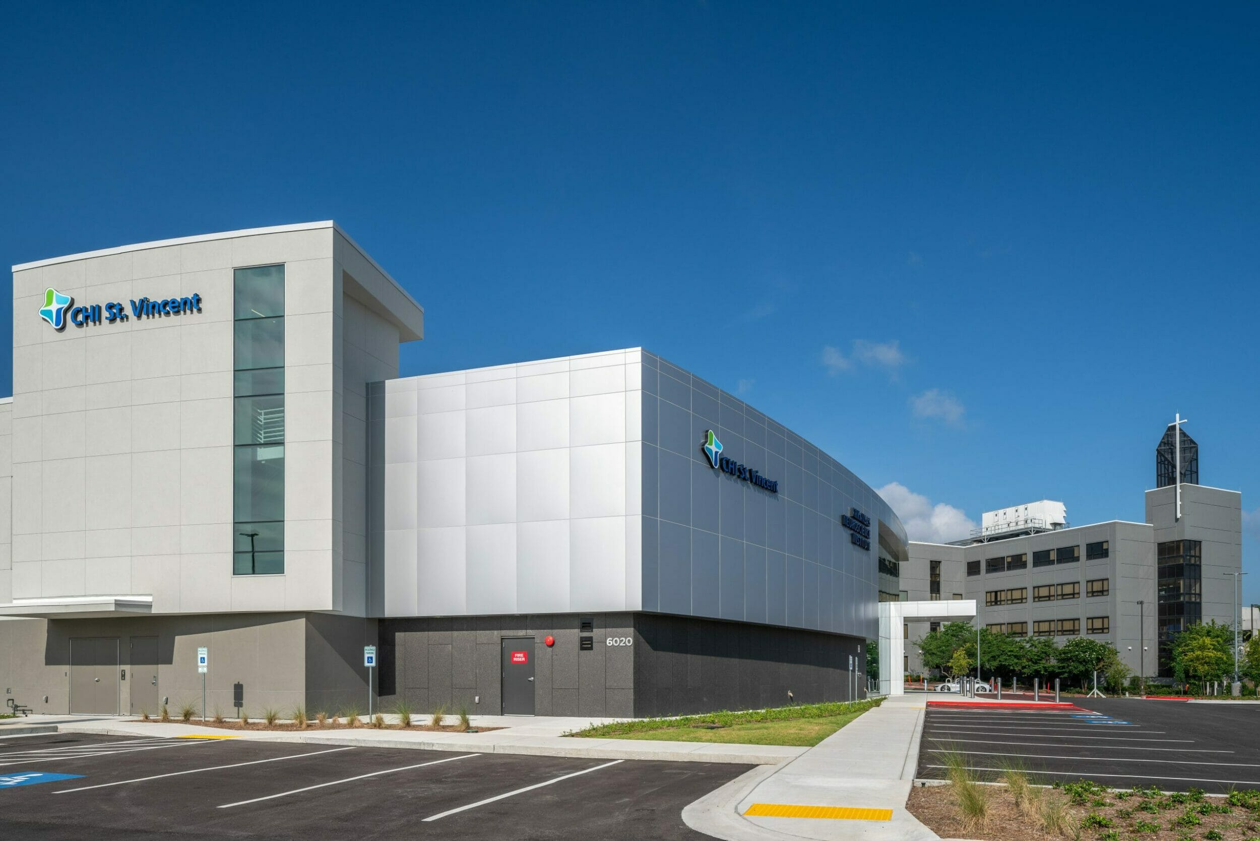 Exterior of CHI St. Vincent with silver and gray exterior with the signage and logo in blue and green