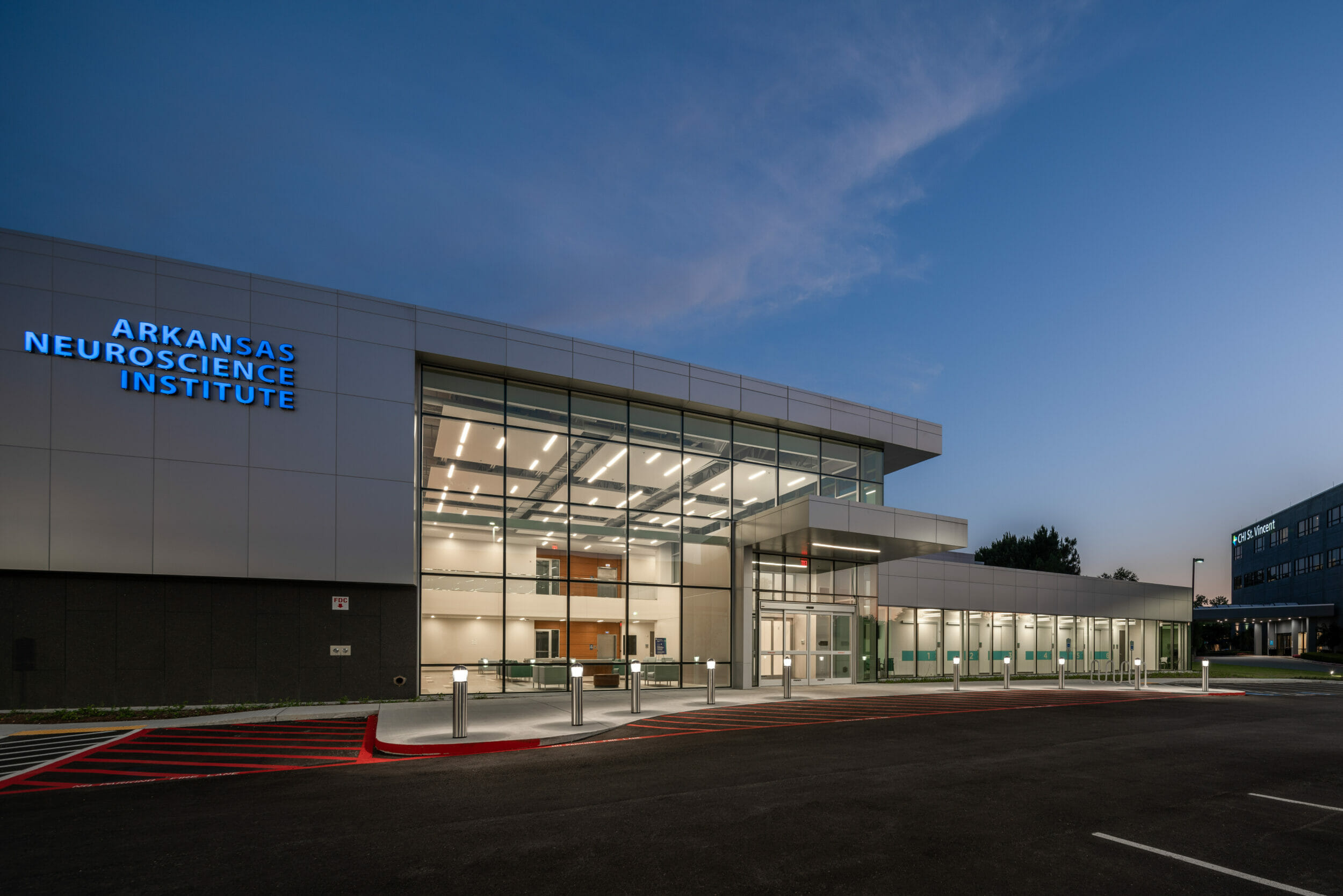 Front of Arkansas Neuroscience Institute at night with tall glass walls