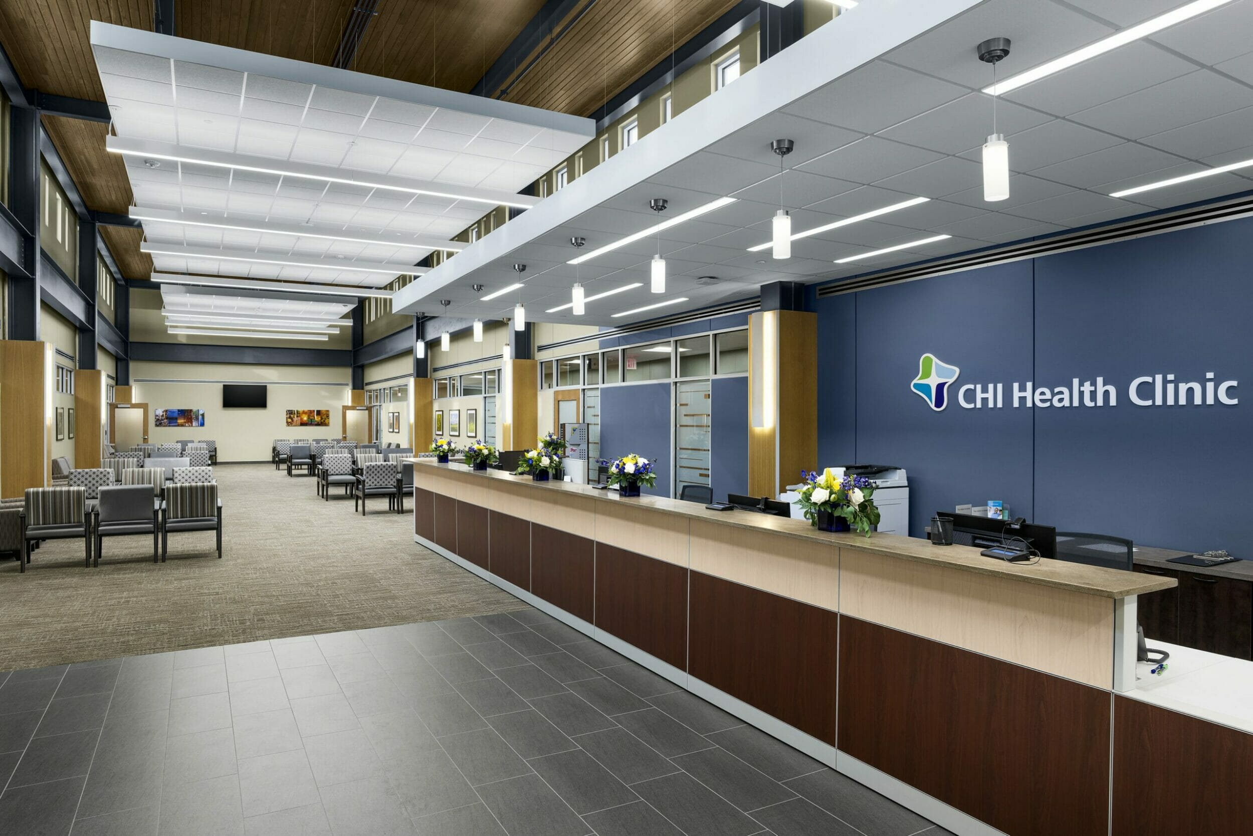 Lobby registration counter, waiting area, blue wall, white lights medical office building