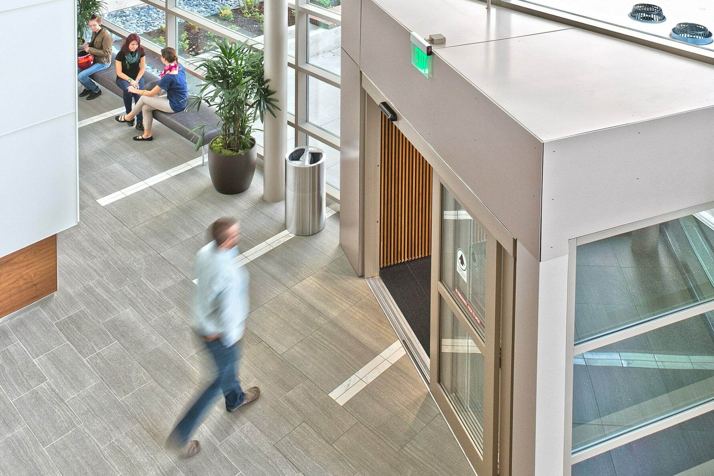 interior view medical pavilion building atrium, man exiting