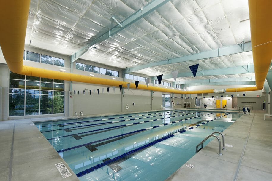 Lap pool inside the UNC Wellness Center at Knightdale with gray and blue painted accents