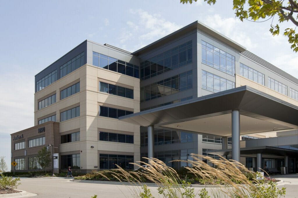 Exterior view silver cross pavilion A, tan and gray building, a lot of windows, large porte-cochère at main entrance