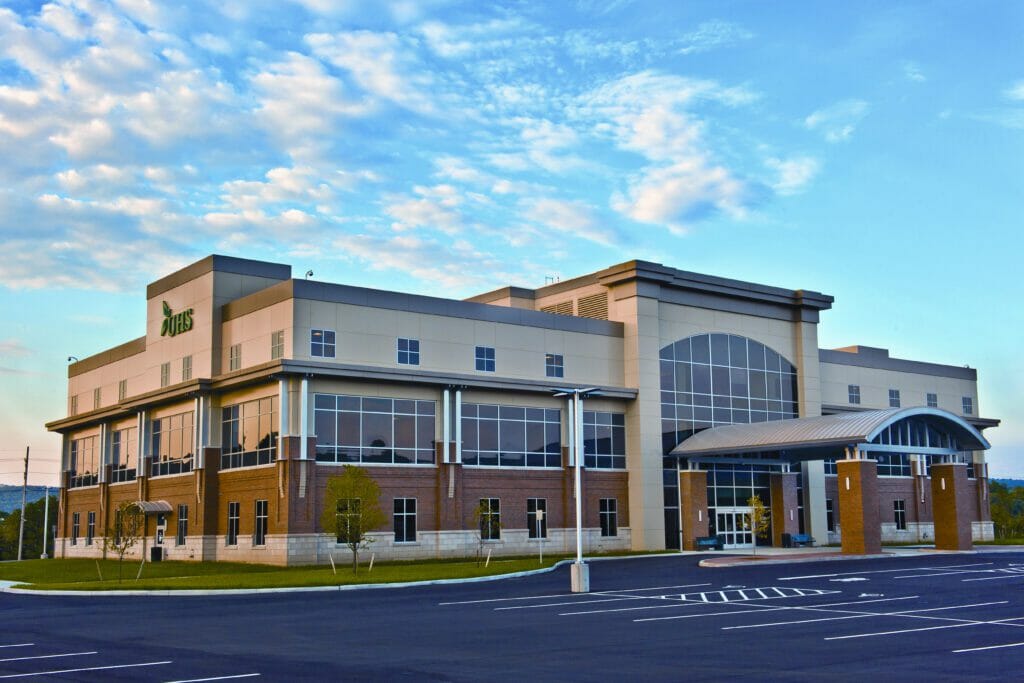 Exterior of a two-story, brick and concrete exterior with parking out front