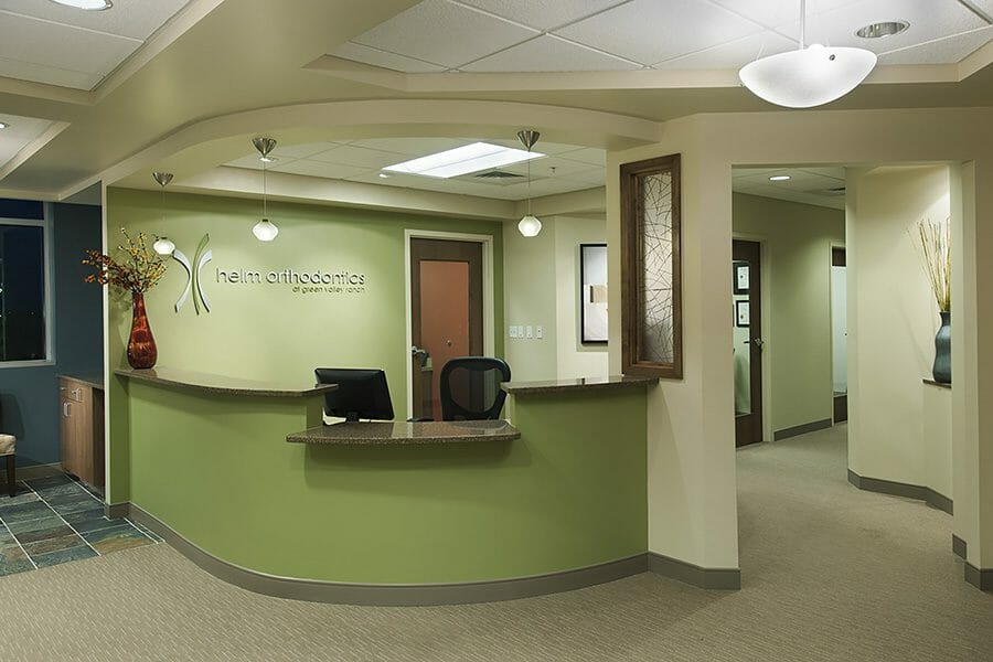 Orthodontics office reception desk, green wall