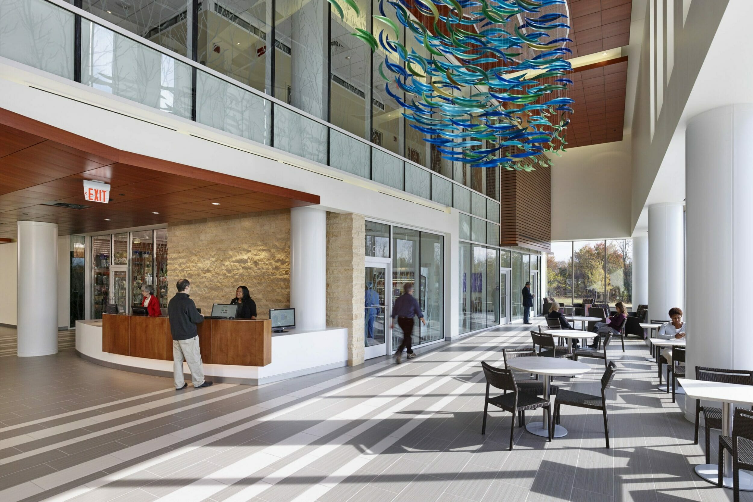 Medical office building atrium, café with seating in atrium, information desk