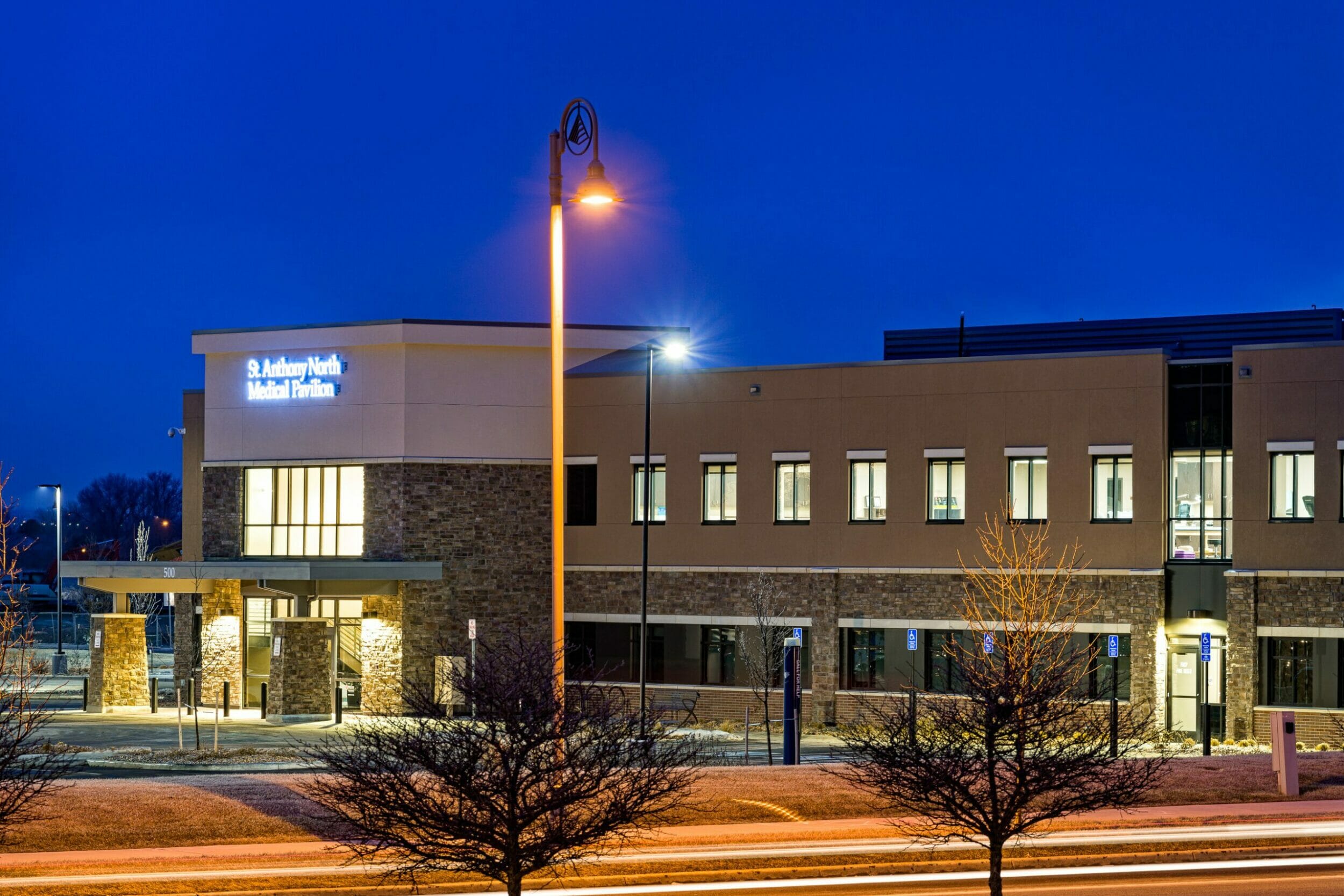 exterior evening view st anthony north medical pavilion, main entrance illuminated